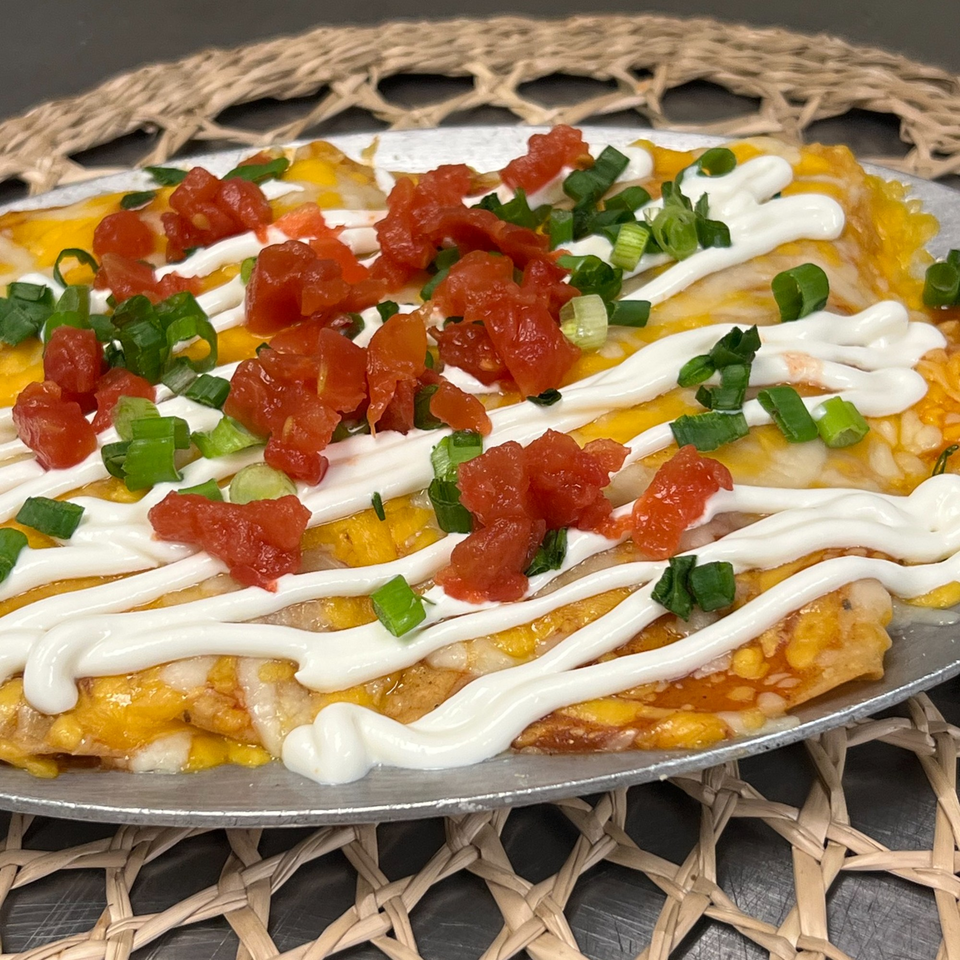 Margarita's Cocina Mexicana's enchiladas topped with melted cheese, sour cream, diced tomatoes, and green onions.
